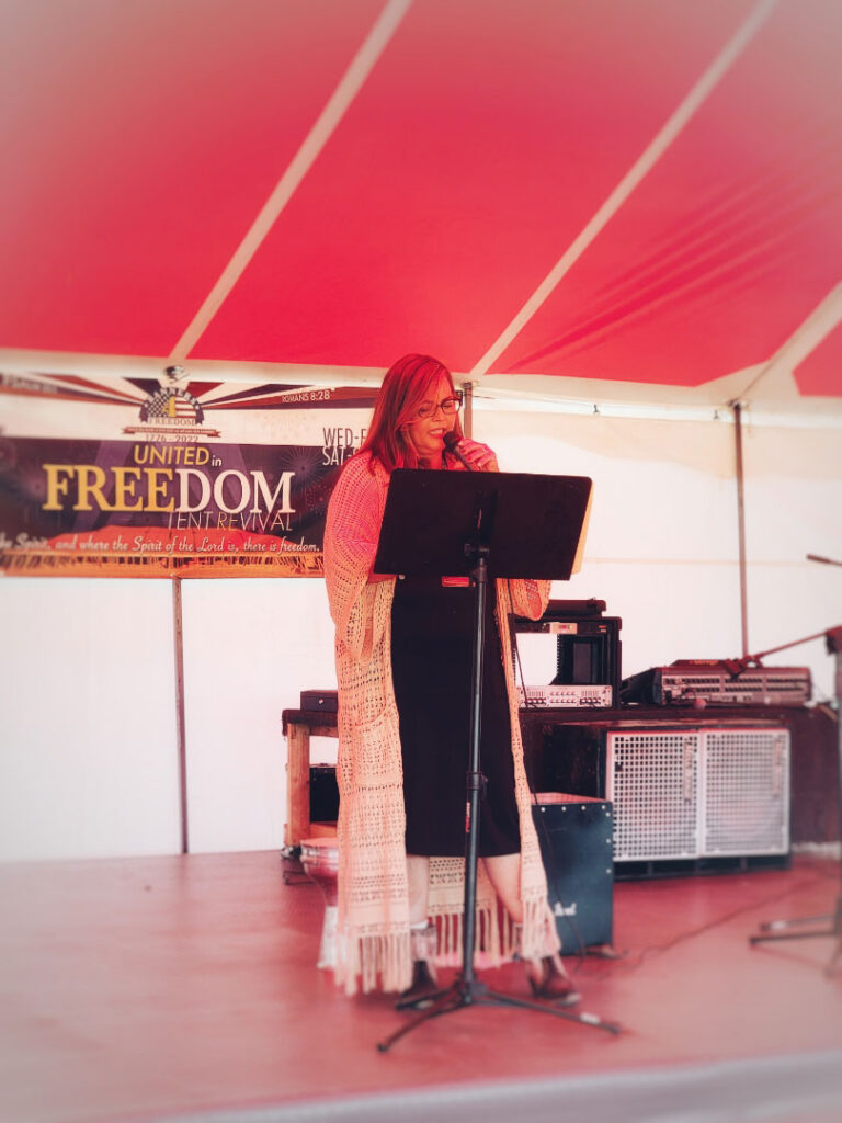 Donica speaking at the United in Freedom Tent Revival